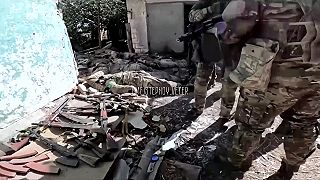 Hromada mŕtvych ukrajinských vojakov a dobre naladení ruskí vojaci