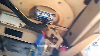 Ruský vojak so obzerá poškodené americké MRAP vozidlo International MaxxPro