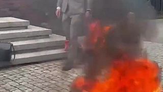 Grzegorz Braun podpaľuje vlajku Európskej únie